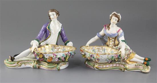 A pair of 19th century Minton reclining figures with baskets in Dresden style, c.1840, height 14cm